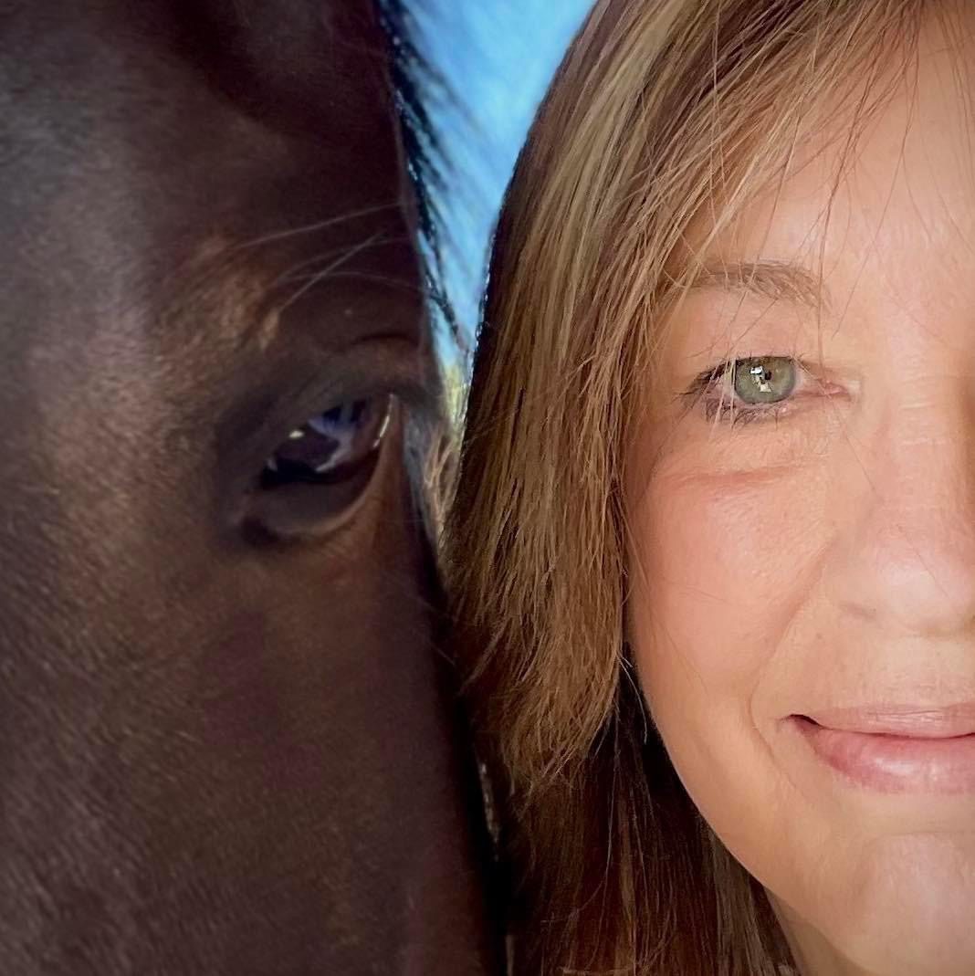 Closeup shot of a woman taking a selfie with horse